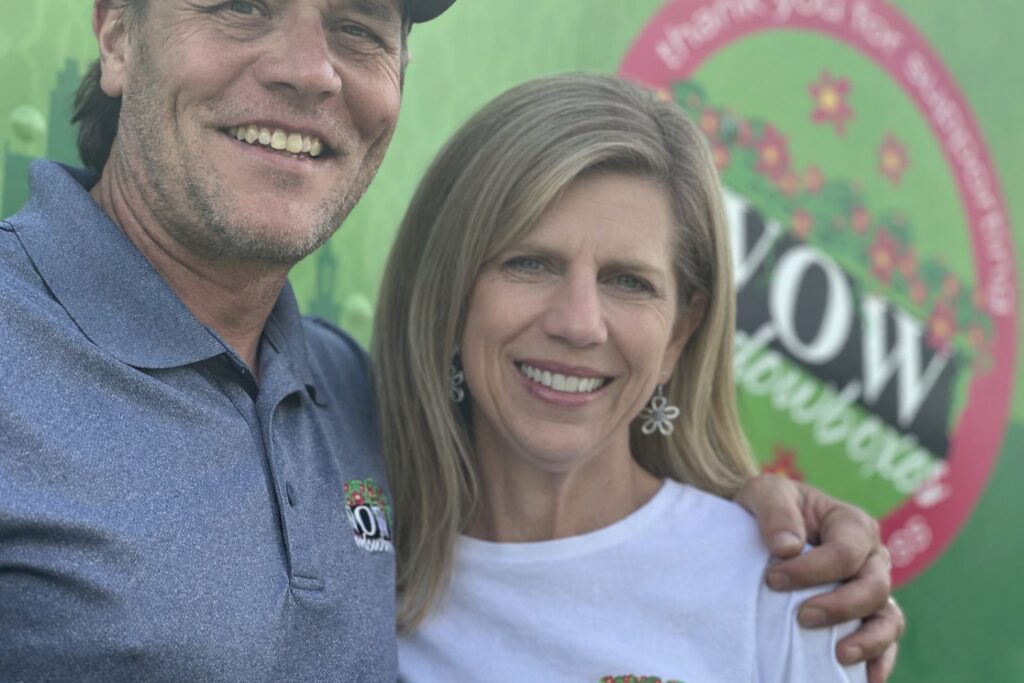 Chad and Julie Roethler WOW Windowboxes Des Moines Stand in front of their branded truck
